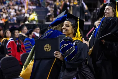 Students hugging during graduation 