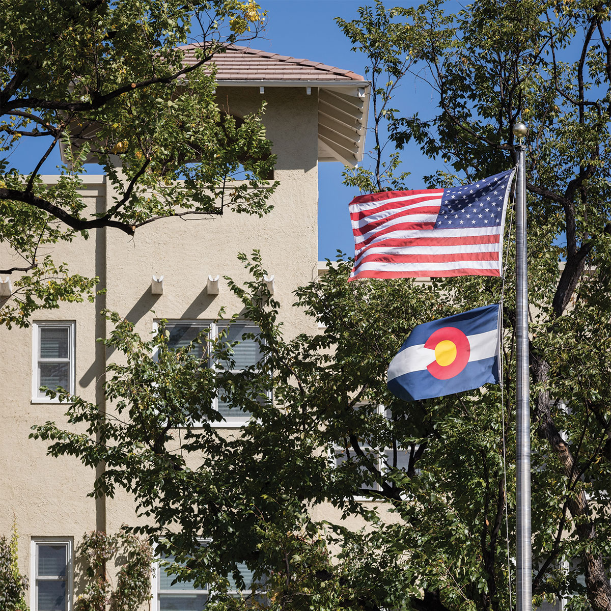 USA and Colorado flags in front of Main Hall